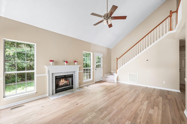 2210 Falcon Creek Dr, Franklin, TN 37067 - unfurnished living room with stairs, wood finished floors, ceiling fan, high vaulted ceiling, and a high end fireplace