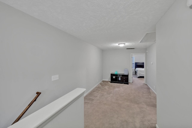 4822 Octavia St, Murfreesboro, TN 37129 - hall featuring attic access, an upstairs landing, light colored carpet, a textured ceiling, and baseboards