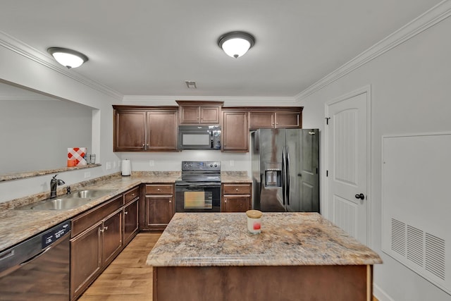 4822 Octavia St, Murfreesboro, TN 37129 - kitchen with black appliances, a sink, light wood-style floors, crown molding, and light stone countertops