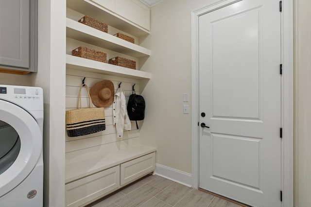 7271 Murrel Dr, Franklin, TN 37064 - laundry room with washer / dryer, baseboards, cabinet space, and light wood-style floors