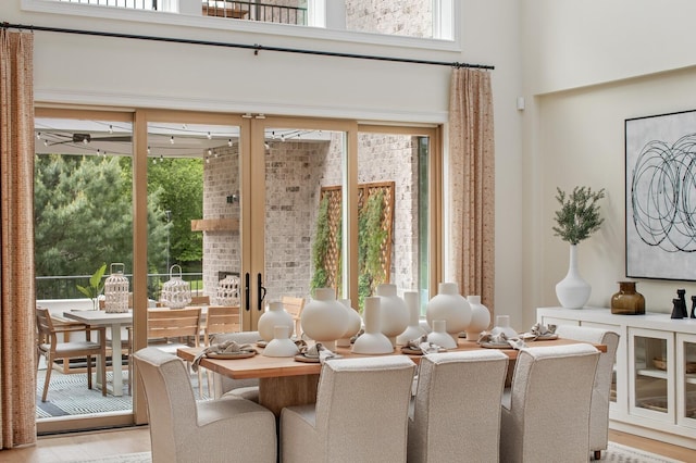 7271 Murrel Dr, Franklin, TN 37064 - dining room featuring healthy amount of natural light, a towering ceiling, light wood-style floors, and a ceiling fan