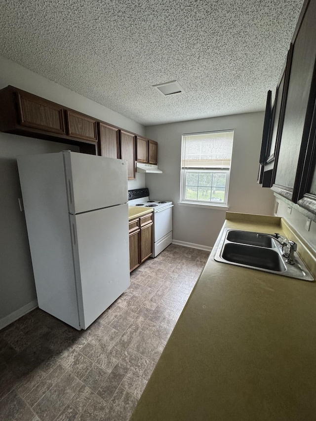 1301 Neelys Bend Rd Unit 43, Madison, TN 37115 - kitchen featuring white appliances, a sink, baseboards, a textured ceiling, and under cabinet range hood