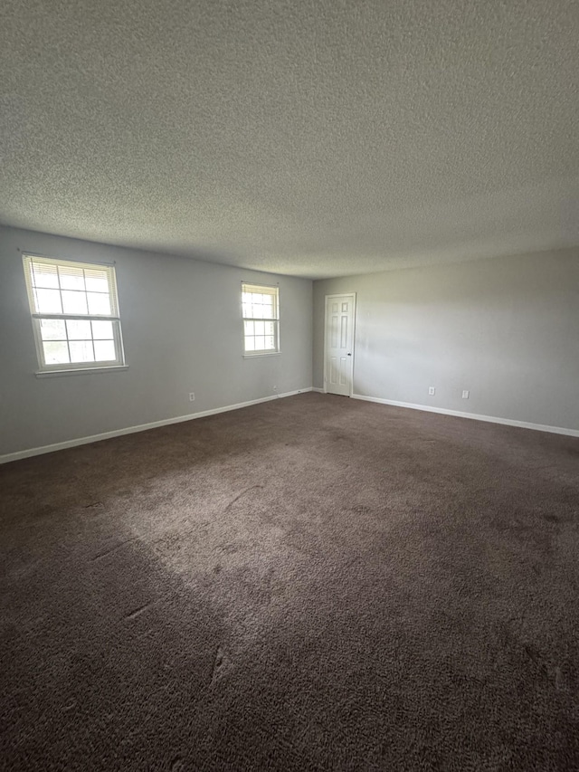 1301 Neelys Bend Rd Unit 43, Madison, TN 37115 - spare room featuring a textured ceiling, baseboards, and dark colored carpet