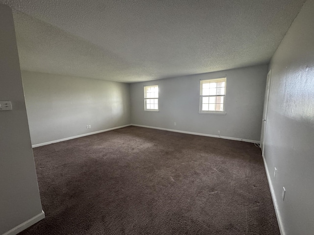 1301 Neelys Bend Rd Unit 43, Madison, TN 37115 - spare room featuring a textured ceiling, dark carpet, and baseboards