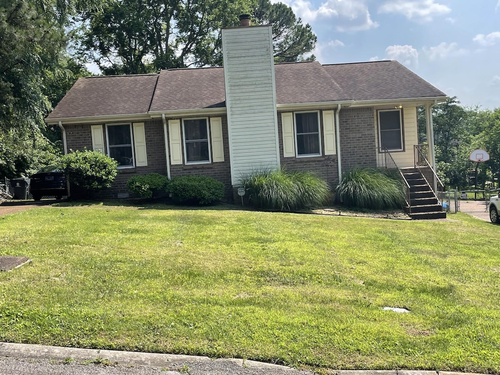 3309 Cedar Ridge Rd, Nashville, TN 37214 - view of front of property with brick siding, a chimney, a front yard, stairs, and a shingled roof