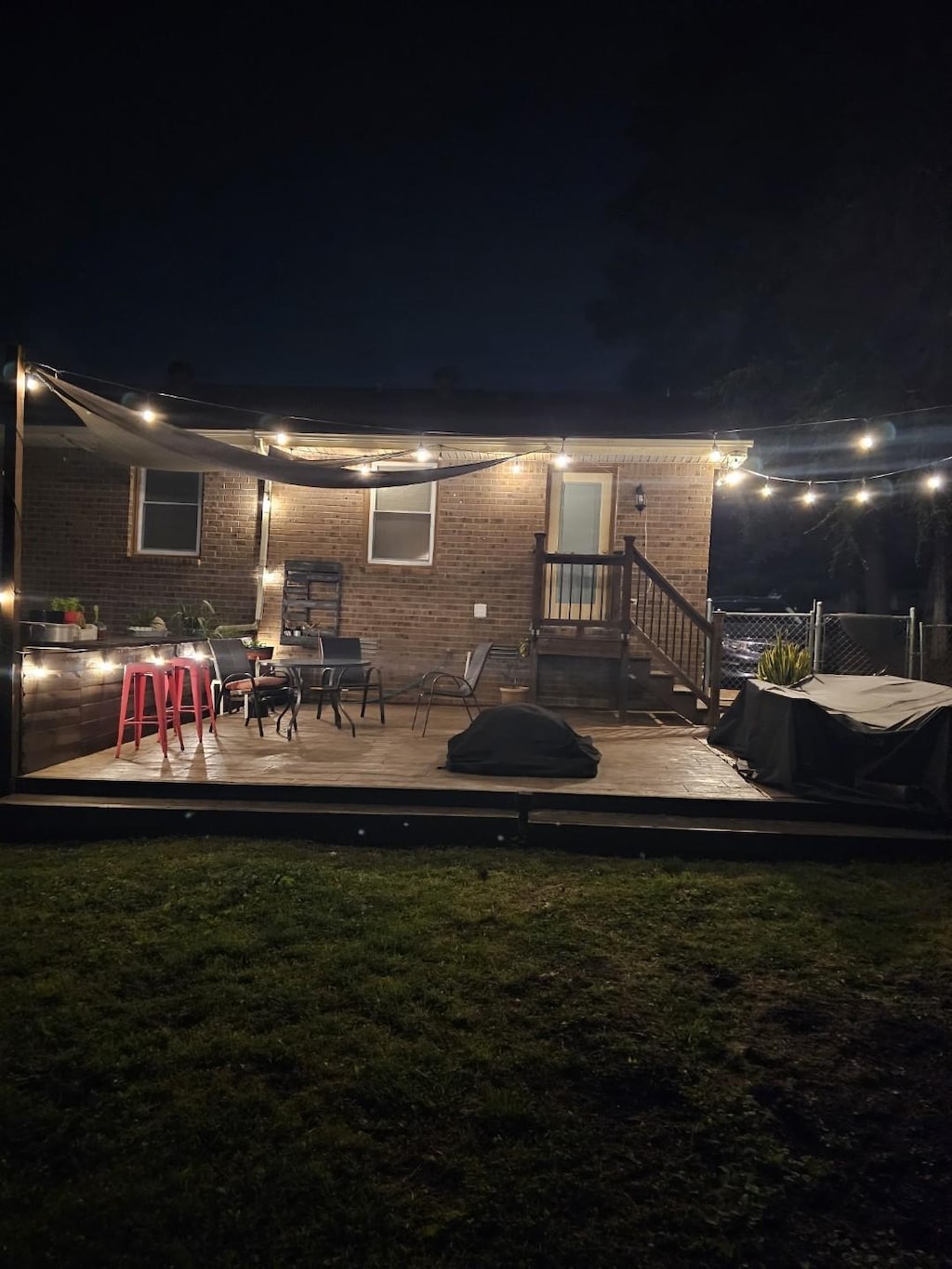 3309 Cedar Ridge Rd, Nashville, TN 37214 - back of house at twilight featuring brick siding and a wooden deck