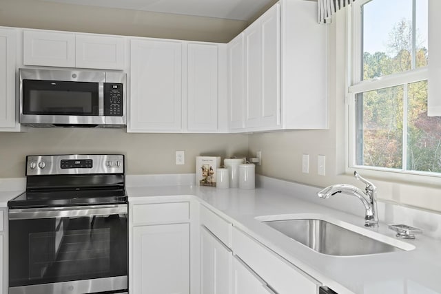100 Walden Way, Gallatin, TN 37066 - kitchen with appliances with stainless steel finishes, a sink, light countertops, and white cabinets