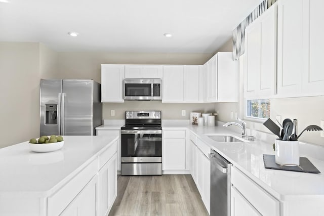 100 Walden Way, Gallatin, TN 37066 - kitchen featuring stainless steel appliances, a sink, light countertops, light wood-type flooring, and white cabinets