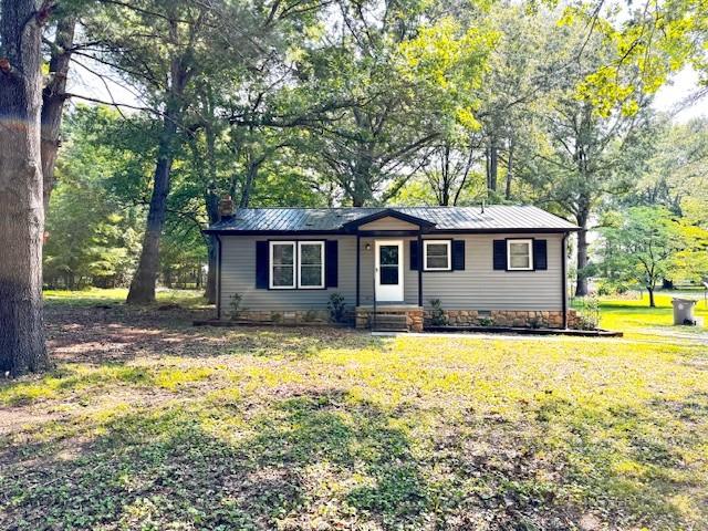 902 Cindy Hollow Rd, Estill Springs, TN 37330 - view of front of home with a chimney, a front lawn, and metal roof