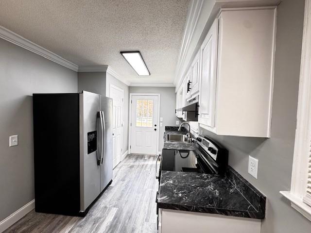 902 Cindy Hollow Rd, Estill Springs, TN 37330 - kitchen with stainless steel fridge, a sink, white cabinetry, light wood-style flooring, and ornamental molding