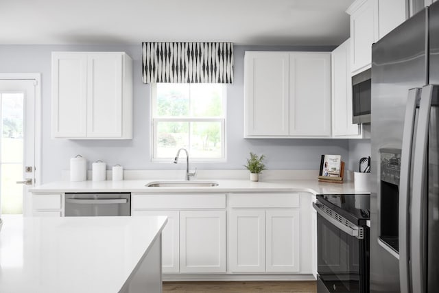 1680 Laurel St, Gallatin, TN 37066 - kitchen featuring stainless steel appliances, a sink, light countertops, and white cabinetry