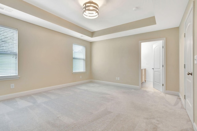 356 Irvine Ln, Franklin, TN 37064 - unfurnished room featuring light colored carpet, a tray ceiling, baseboards, and a smoke detector