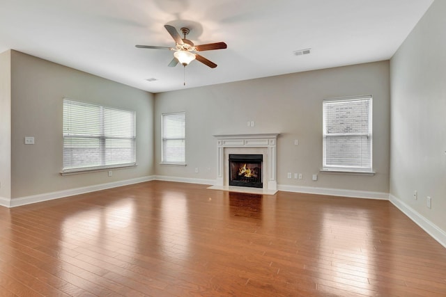 356 Irvine Ln, Franklin, TN 37064 - unfurnished living room featuring a ceiling fan, hardwood / wood-style flooring, a premium fireplace, and baseboards