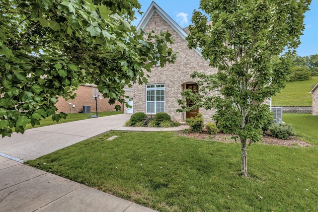 356 Irvine Ln, Franklin, TN 37064 - view of front of property featuring brick siding, concrete driveway, a front lawn, and central AC unit