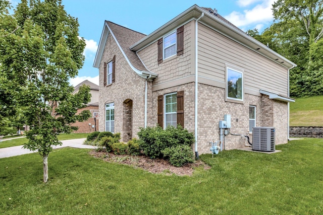 356 Irvine Ln, Franklin, TN 37064 - view of property exterior featuring central AC, brick siding, and a yard