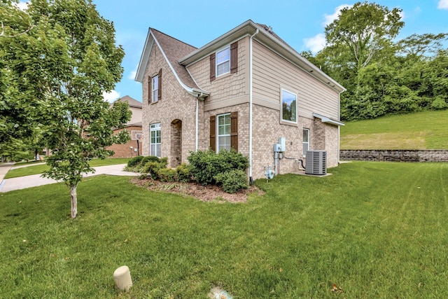 356 Irvine Ln, Franklin, TN 37064 - view of front of house with cooling unit, brick siding, and a front yard