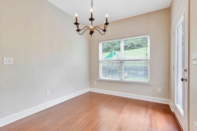 356 Irvine Ln, Franklin, TN 37064 - unfurnished dining area featuring a chandelier, healthy amount of natural light, wood finished floors, and baseboards