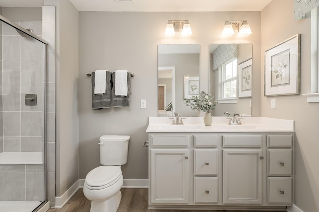 1171 Savannah Ave, Gallatin, TN 37066 - full bathroom with double vanity, toilet, a shower stall, and wood finished floors