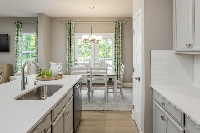 1171 Savannah Ave, Gallatin, TN 37066 - kitchen featuring a sink, a chandelier, light wood-style floors, light countertops, and stainless steel dishwasher