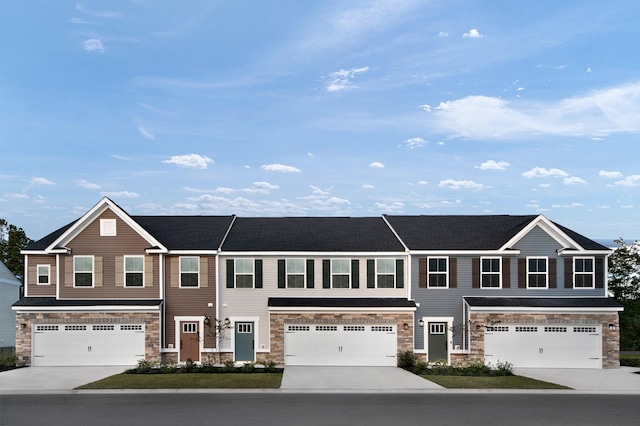 1171 Savannah Ave, Gallatin, TN 37066 - townhome / multi-family property with stone siding, a garage, and concrete driveway