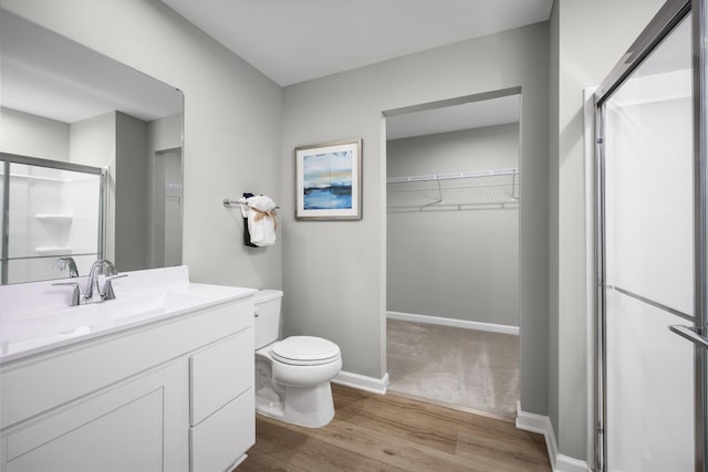 1296 Laurel St, Gallatin, TN 37066 - full bathroom featuring a spacious closet, toilet, a shower stall, and wood finished floors