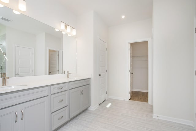 3263 Kemp Dr, Hermitage, TN 37076 - full bathroom with double vanity, baseboards, recessed lighting, and a spacious closet