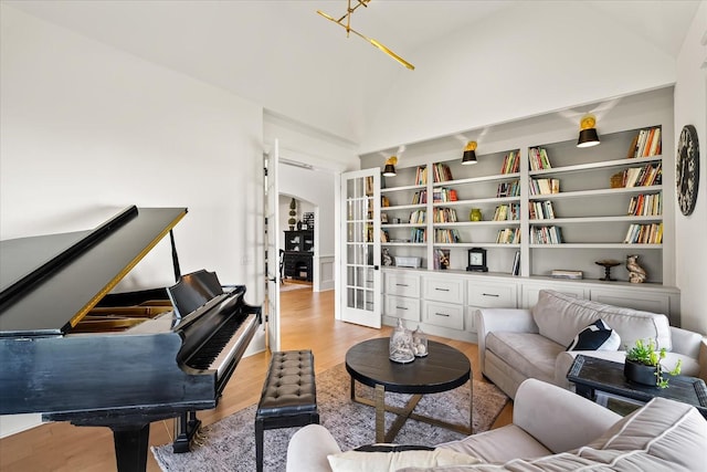 1750 Barrow Ln, Brentwood, TN 37027 - sitting room with lofted ceiling, light wood finished floors, french doors, and built in shelves