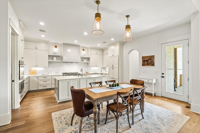 1750 Barrow Ln, Brentwood, TN 37027 - dining area featuring arched walkways, light wood-style floors, and recessed lighting