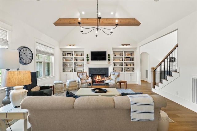 1750 Barrow Ln, Brentwood, TN 37027 - living room with beamed ceiling, a fireplace, wood finished floors, stairs, and arched walkways