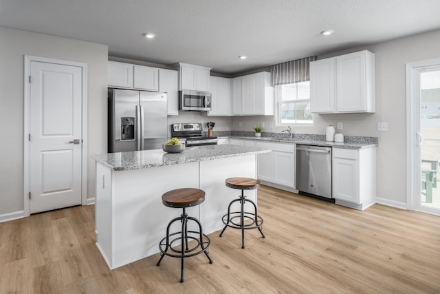 1553 Thornton Grove Blvd, Nashville, TN 37207 - kitchen featuring stainless steel appliances, a sink, white cabinets, a center island, and recessed lighting
