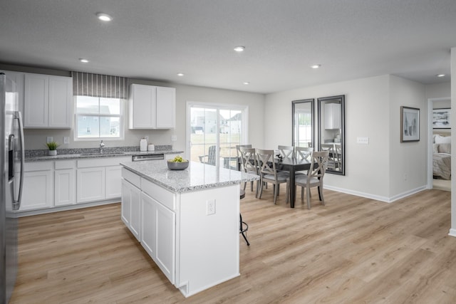 1553 Thornton Grove Blvd, Nashville, TN 37207 - kitchen with a sink, stainless steel appliances, a kitchen island, white cabinetry, and light stone counters