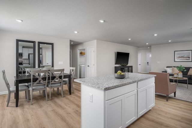 1553 Thornton Grove Blvd, Nashville, TN 37207 - kitchen with light wood finished floors, a center island, appliances with stainless steel finishes, open floor plan, and white cabinets