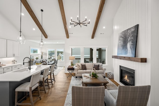 1005 Cherry Tree Dr, Mount Juliet, TN 37122 - living room with light wood-type flooring, a glass covered fireplace, a chandelier, and recessed lighting