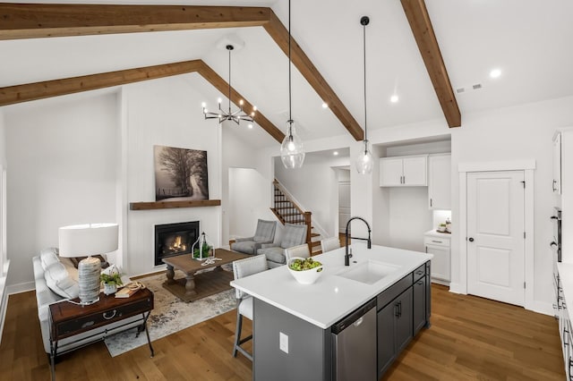 1005 Cherry Tree Dr, Mount Juliet, TN 37122 - kitchen with a sink, stainless steel dishwasher, beamed ceiling, a glass covered fireplace, and white cabinets