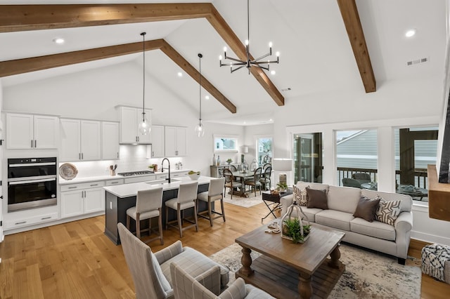 1005 Cherry Tree Dr, Mount Juliet, TN 37122 - living room with beamed ceiling, high vaulted ceiling, light wood-style flooring, a chandelier, and recessed lighting