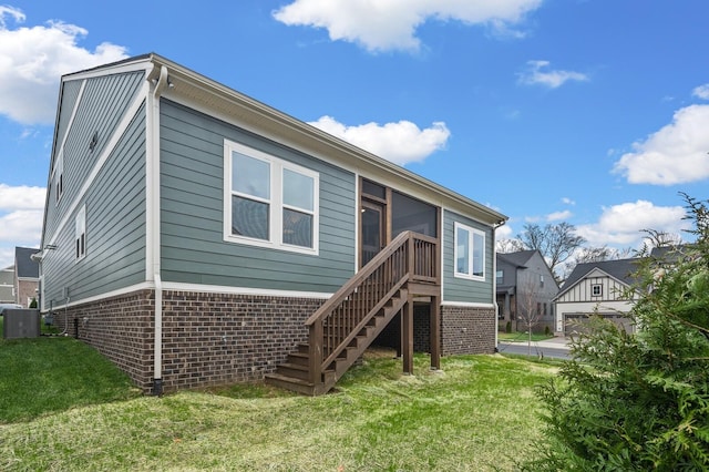 1005 Cherry Tree Dr, Mount Juliet, TN 37122 - rear view of house featuring brick siding, a lawn, stairs, central air condition unit, and a sunroom