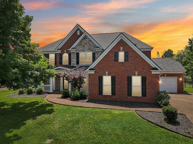 102 Oglethorpe Ave, Gallatin, TN 37066 - view of front facade with an attached garage, a lawn, driveway, a shingled roof, and brick siding