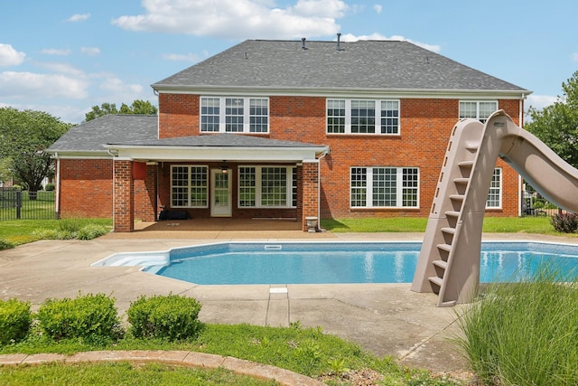 102 Oglethorpe Ave, Gallatin, TN 37066 - back of property featuring a patio, brick siding, and a shingled roof