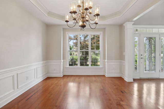 102 Oglethorpe Ave, Gallatin, TN 37066 - unfurnished dining area featuring a chandelier, a tray ceiling, a wainscoted wall, hardwood / wood-style floors, and crown molding