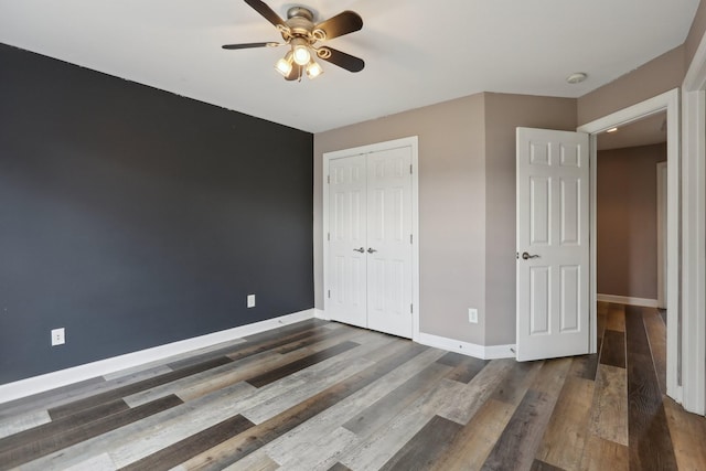 102 Oglethorpe Ave, Gallatin, TN 37066 - unfurnished bedroom featuring a closet, baseboards, wood finished floors, and ceiling fan