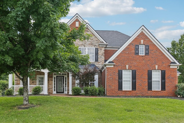 102 Oglethorpe Ave, Gallatin, TN 37066 - view of front facade with stone siding, a front yard, brick siding, and a porch