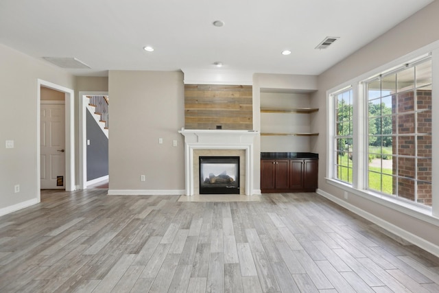 102 Oglethorpe Ave, Gallatin, TN 37066 - unfurnished living room featuring light wood-style flooring, healthy amount of natural light, baseboards, a fireplace, and recessed lighting