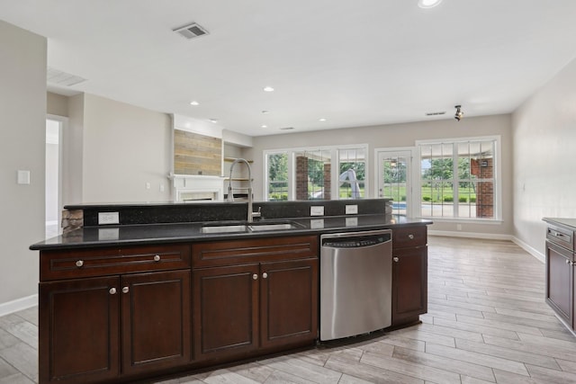 102 Oglethorpe Ave, Gallatin, TN 37066 - kitchen featuring stainless steel dishwasher, a sink, baseboards, light wood finished floors, and recessed lighting