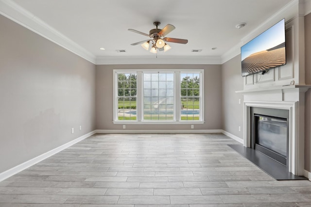102 Oglethorpe Ave, Gallatin, TN 37066 - unfurnished living room featuring a ceiling fan, crown molding, a large fireplace, light wood-type flooring, and baseboards