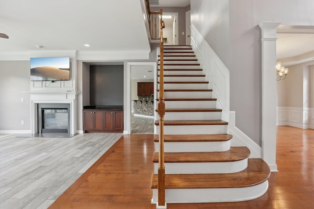 102 Oglethorpe Ave, Gallatin, TN 37066 - stairway with wood finished floors, a glass covered fireplace, a chandelier, and recessed lighting