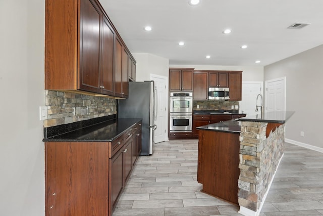102 Oglethorpe Ave, Gallatin, TN 37066 - kitchen featuring stainless steel appliances, a sink, tasteful backsplash, light wood-type flooring, and recessed lighting