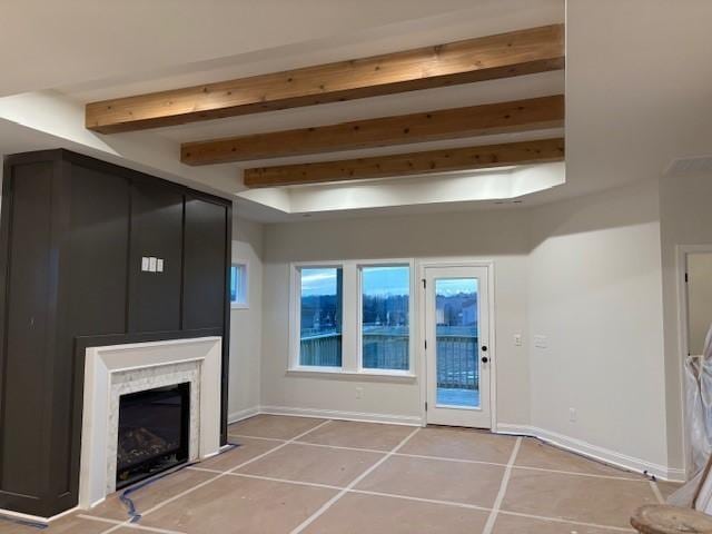 1320 Ashton Park Dr, Mount Juliet, TN 37122 - unfurnished living room featuring tile patterned flooring, a fireplace, baseboards, and beam ceiling