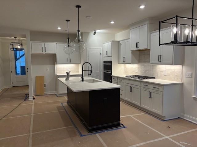 1320 Ashton Park Dr, Mount Juliet, TN 37122 - kitchen with a sink, tasteful backsplash, stainless steel gas cooktop, a kitchen island with sink, and baseboards