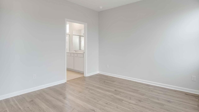 6454 Japonica Ln, White House, TN 37188 - empty room with light wood-type flooring, baseboards, and a sink
