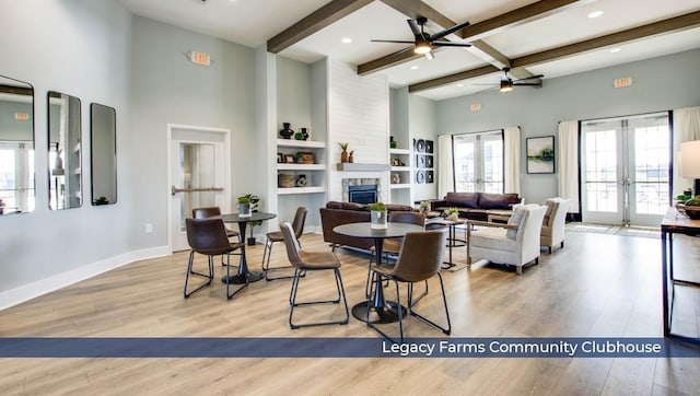 6454 Japonica Ln, White House, TN 37188 - dining space with ceiling fan, a stone fireplace, wood finished floors, beam ceiling, and baseboards